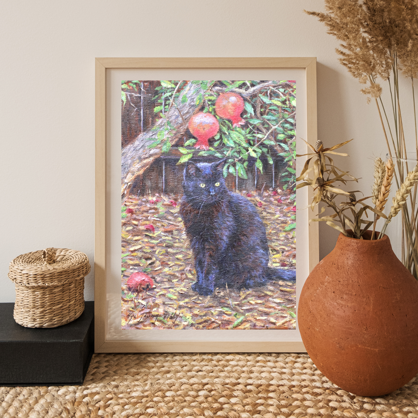 Black cat by pomegranate tree